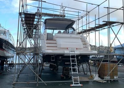 A yacht having work done in yacht surrounded by scaffolding